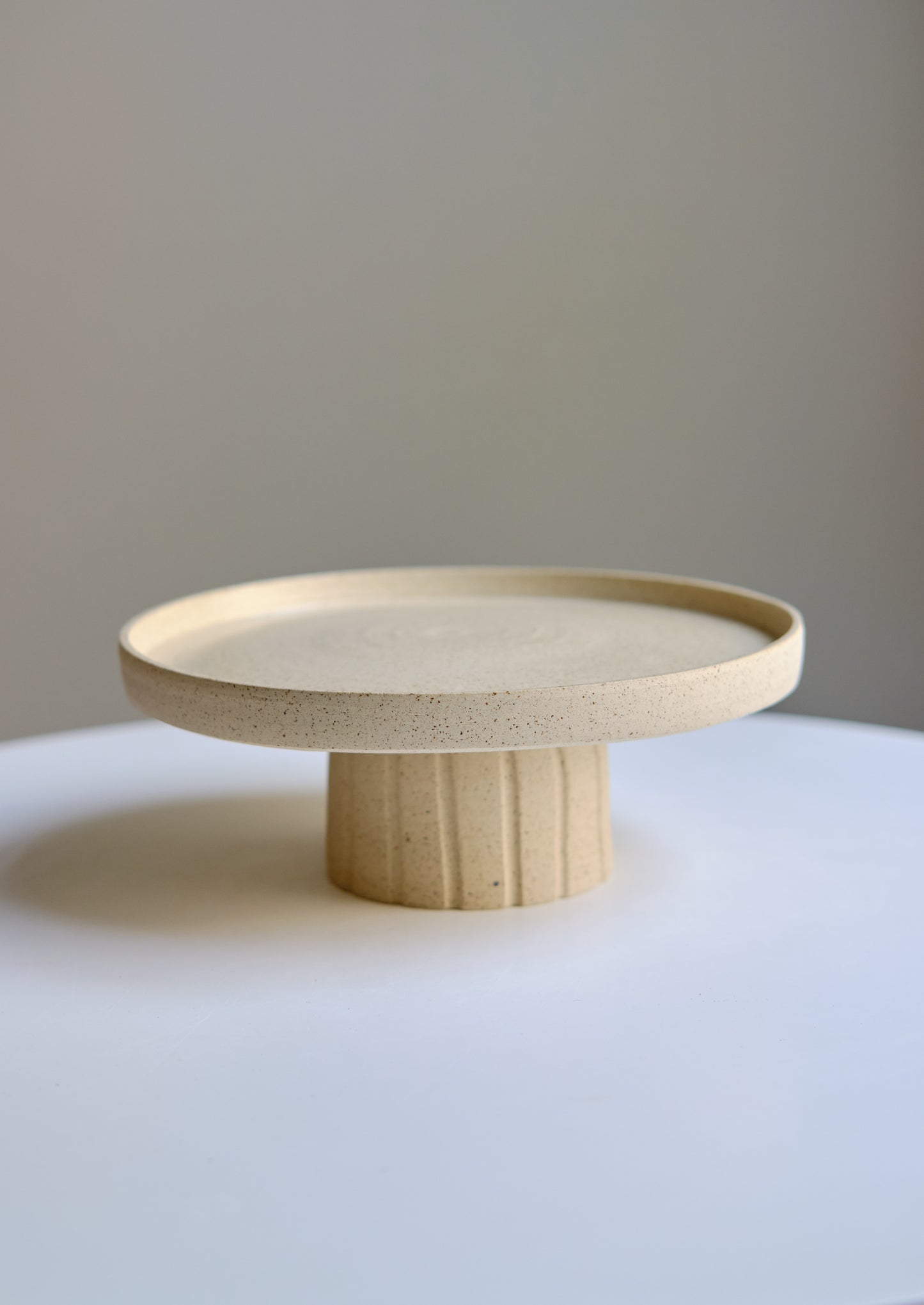 Cake stand with carved foot